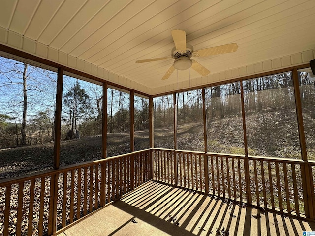 unfurnished sunroom with ceiling fan