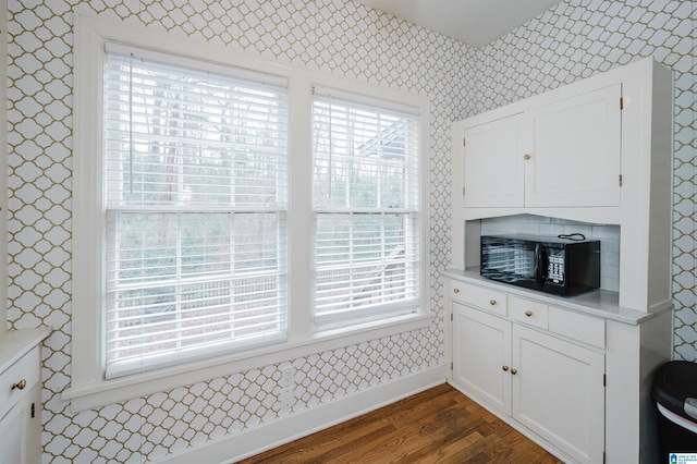 kitchen with white cabinets and dark hardwood / wood-style flooring