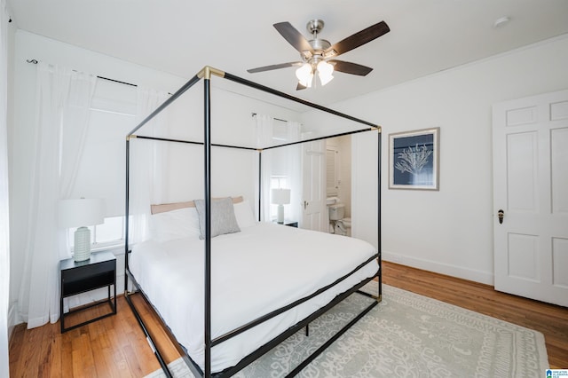 bedroom featuring connected bathroom, ceiling fan, and hardwood / wood-style floors