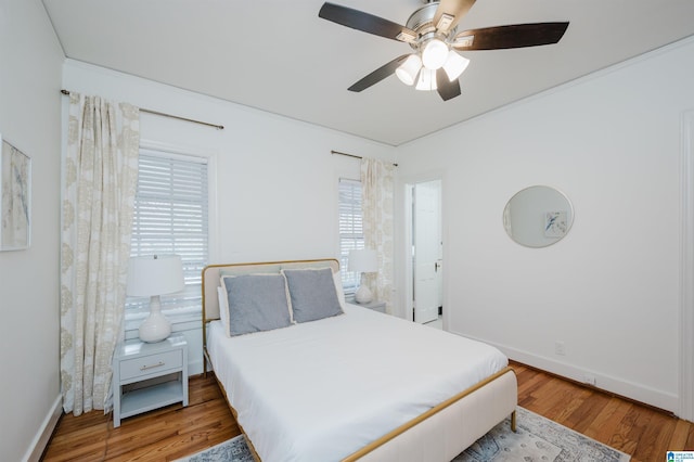 bedroom with ceiling fan and hardwood / wood-style flooring