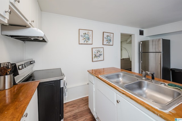 kitchen featuring white cabinets, sink, stainless steel refrigerator, range, and extractor fan