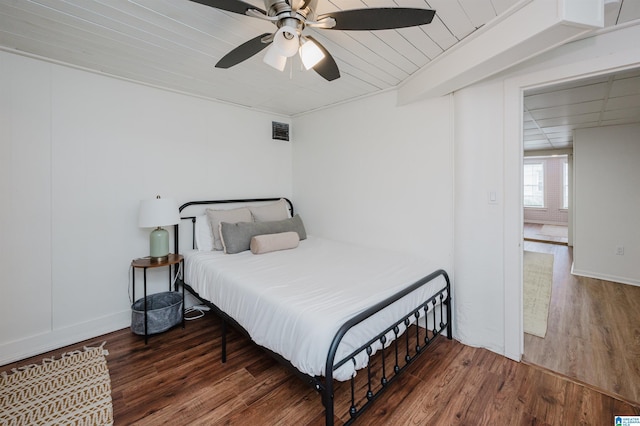 bedroom with ceiling fan and dark wood-type flooring