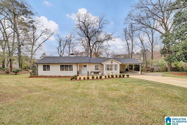 single story home featuring a carport and a front yard