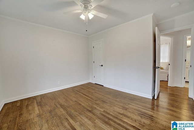 empty room with ceiling fan, dark hardwood / wood-style flooring, and ornamental molding