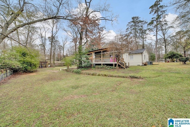 view of yard featuring a deck and central air condition unit