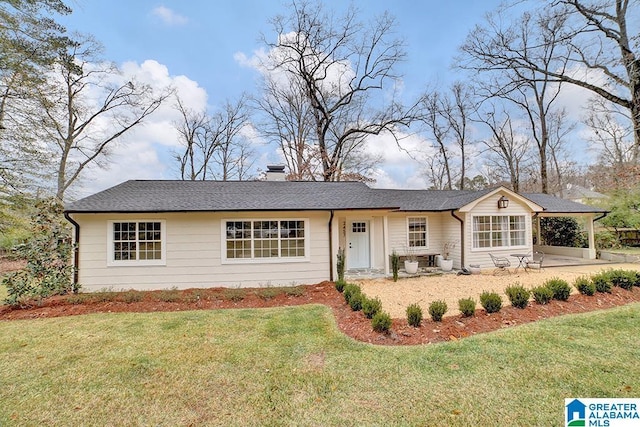 single story home featuring a front yard and a patio area