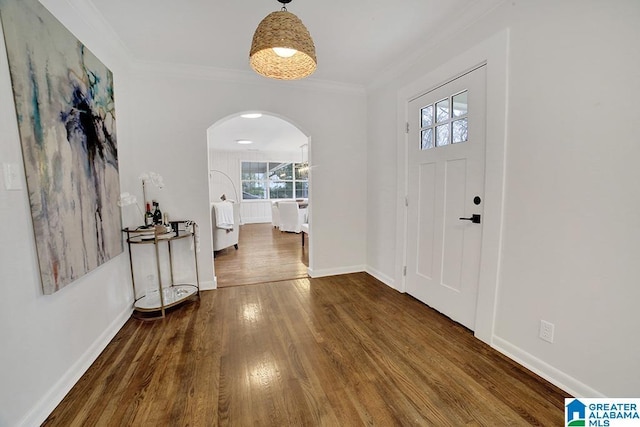 foyer with crown molding and hardwood / wood-style floors