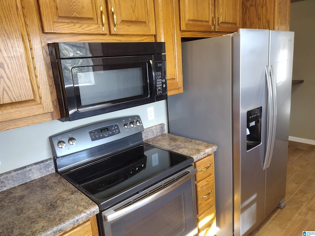 kitchen with wood-type flooring and appliances with stainless steel finishes