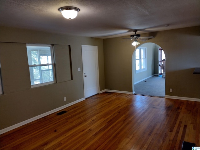 interior space featuring a textured ceiling, dark hardwood / wood-style flooring, and ceiling fan