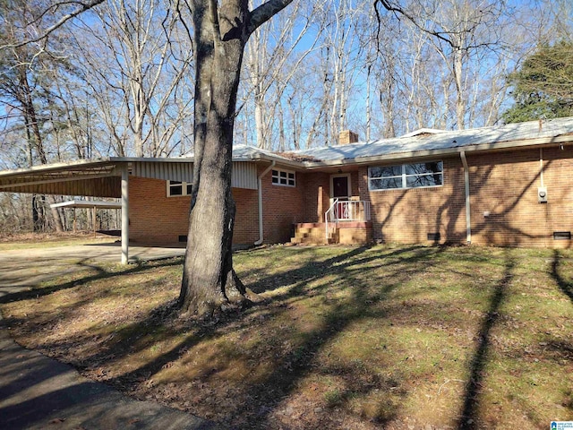 rear view of property with a yard and a carport