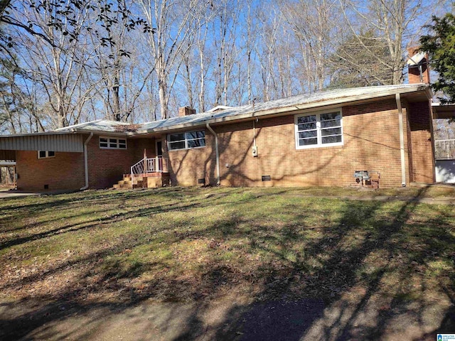 rear view of property with a lawn