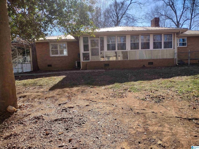 back of property with a sunroom