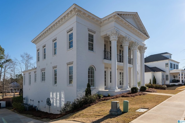 view of front of home featuring a balcony and cooling unit