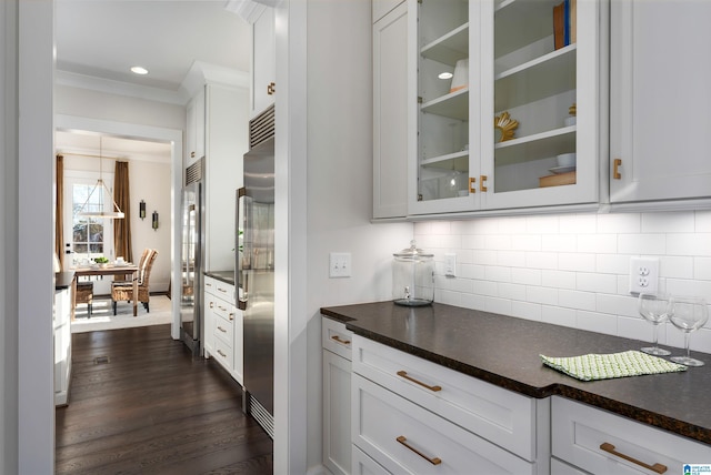 bar with white cabinets, backsplash, built in fridge, and dark wood-type flooring