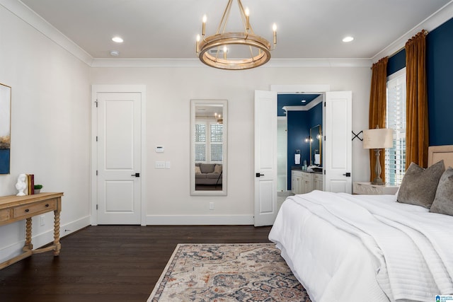 bedroom with a chandelier, ensuite bath, dark wood-type flooring, and crown molding