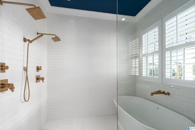 bathroom featuring plus walk in shower, tile patterned floors, tile walls, and a healthy amount of sunlight