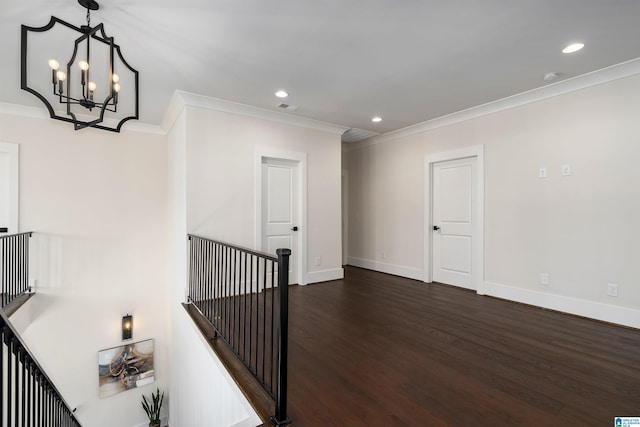 stairs featuring wood-type flooring, crown molding, and an inviting chandelier