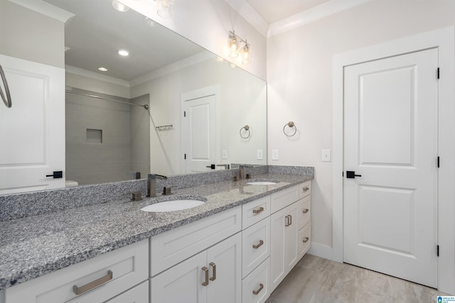 bathroom with vanity, a shower, and ornamental molding