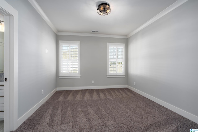 unfurnished room with ornamental molding, carpet floors, and a wealth of natural light