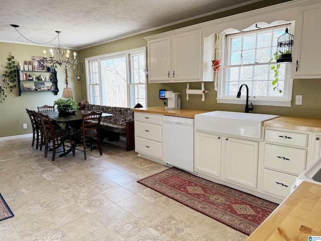 kitchen with butcher block countertops, white dishwasher, and pendant lighting