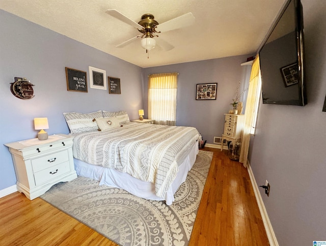 bedroom with ceiling fan and wood-type flooring