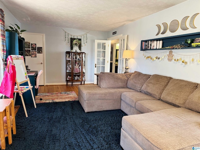 living room with french doors, wood-type flooring, and a textured ceiling