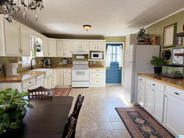 kitchen featuring white appliances, sink, ornamental molding, a textured ceiling, and white cabinetry