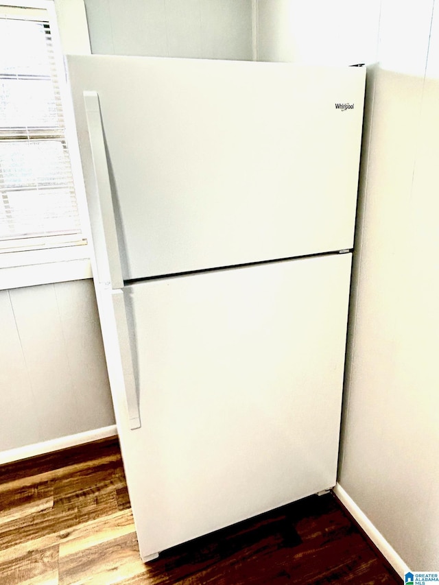 room details featuring hardwood / wood-style floors and white fridge