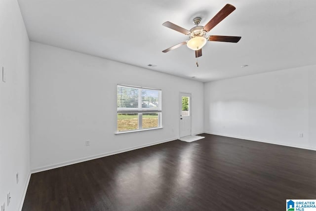 spare room with ceiling fan and dark hardwood / wood-style flooring