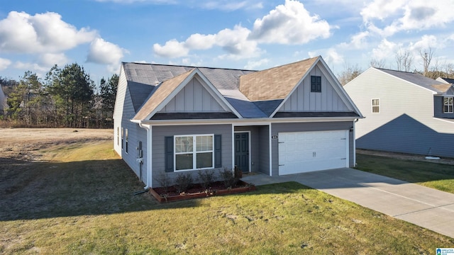 view of front of property featuring a front yard and a garage