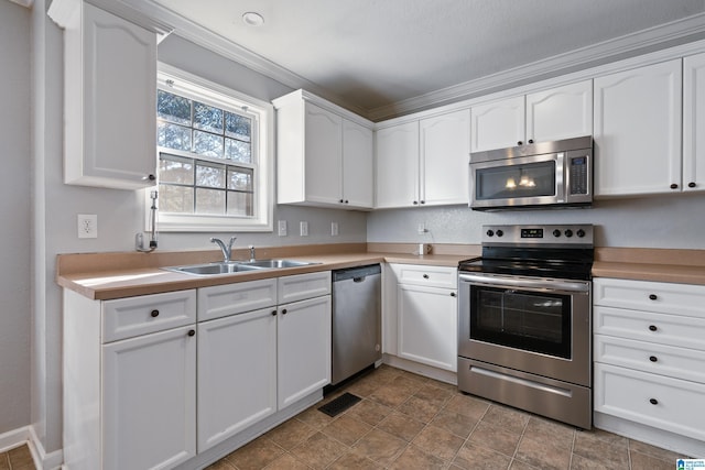 kitchen with appliances with stainless steel finishes, white cabinetry, and sink