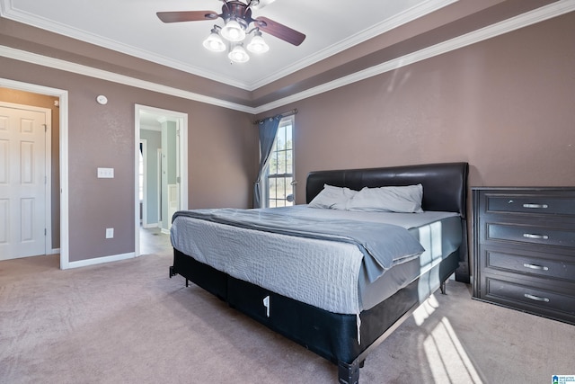 bedroom with ceiling fan, light colored carpet, ornamental molding, and ensuite bath