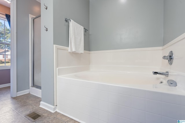 bathroom featuring tile patterned floors and separate shower and tub