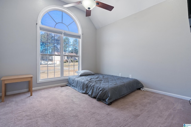 carpeted bedroom with ceiling fan and lofted ceiling