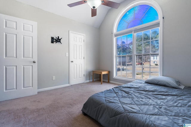 carpeted bedroom with ceiling fan and vaulted ceiling