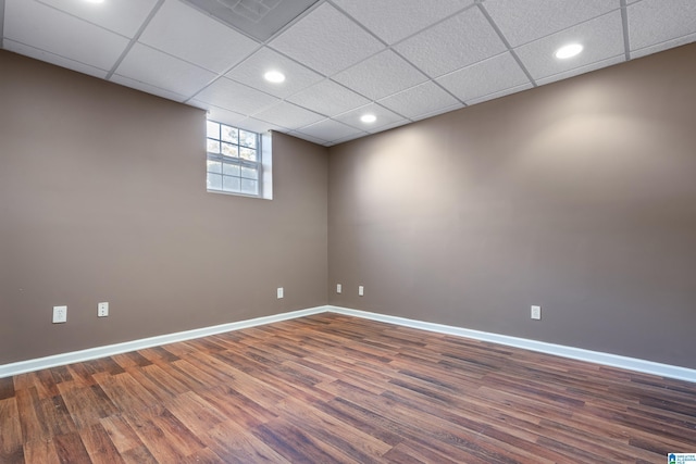 unfurnished room featuring a drop ceiling and dark hardwood / wood-style flooring