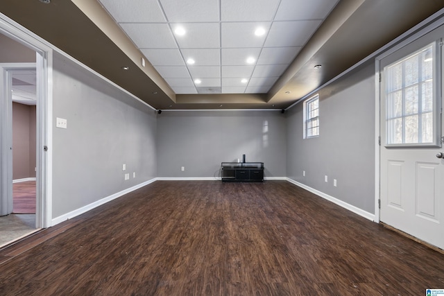 unfurnished living room with hardwood / wood-style flooring, a tray ceiling, and a paneled ceiling