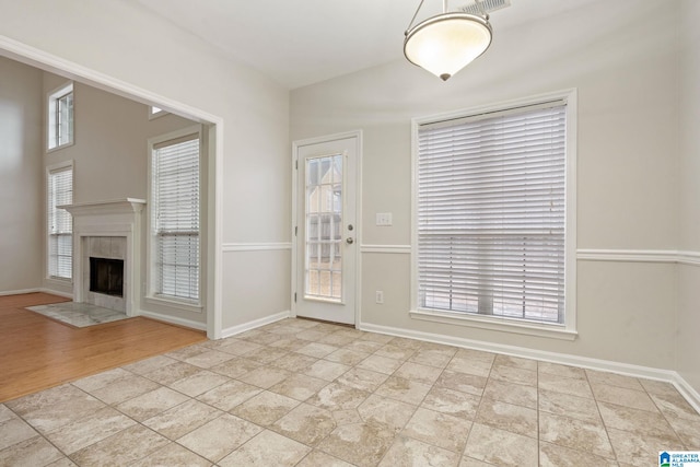 interior space with light tile patterned floors and a premium fireplace