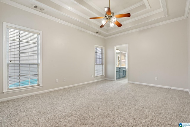 carpeted spare room featuring ceiling fan, crown molding, and a tray ceiling