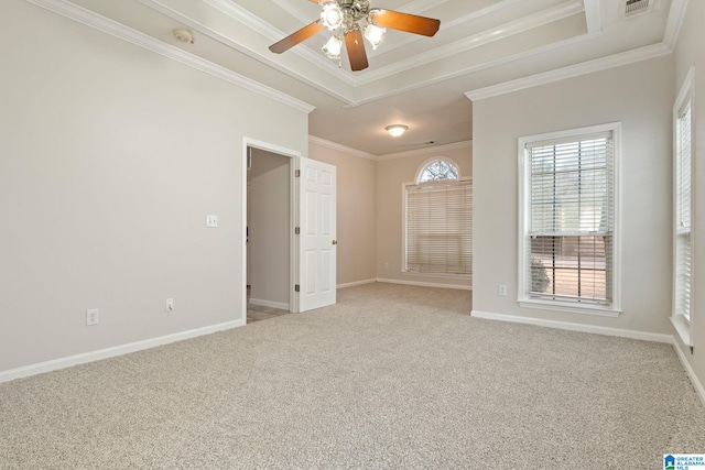 spare room with ceiling fan, crown molding, and light carpet