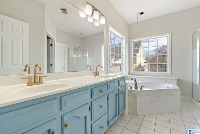 bathroom featuring plus walk in shower, vanity, and tile patterned floors