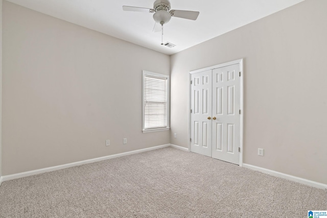 carpeted empty room with ceiling fan