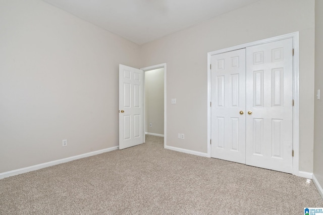 unfurnished bedroom featuring carpet flooring and a closet