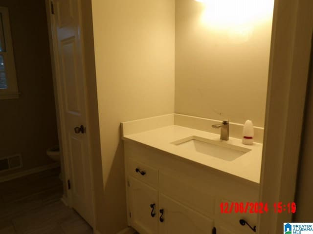 bathroom with vanity and toilet