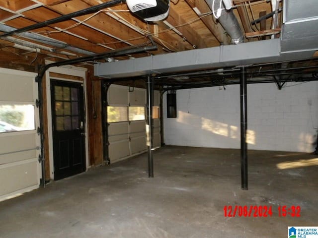 garage featuring electric panel and a garage door opener