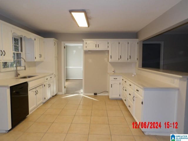 kitchen featuring light tile patterned floors, black dishwasher, white cabinetry, and sink