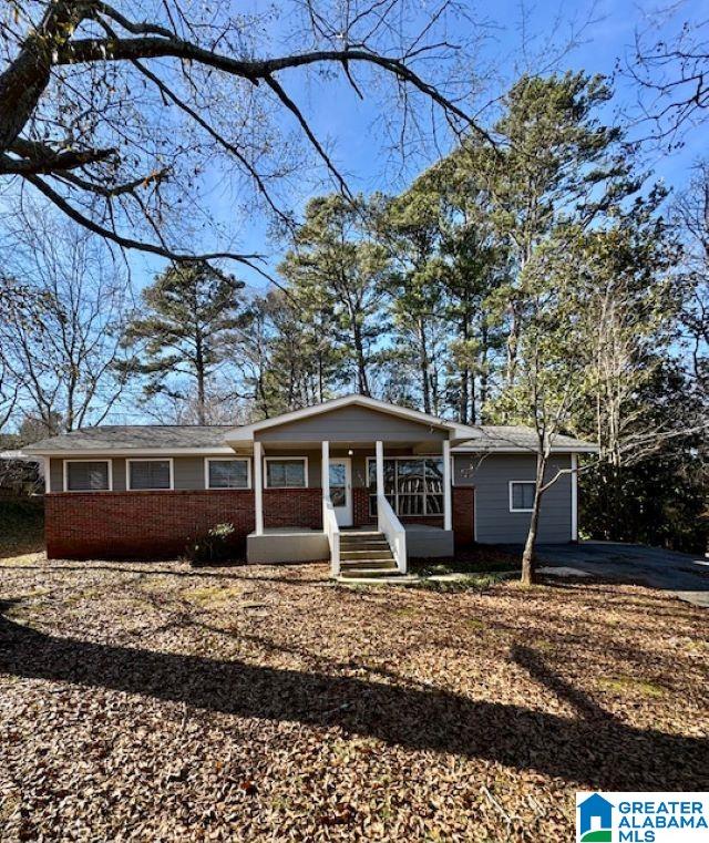 single story home featuring covered porch