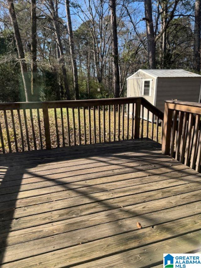 wooden terrace featuring a storage unit