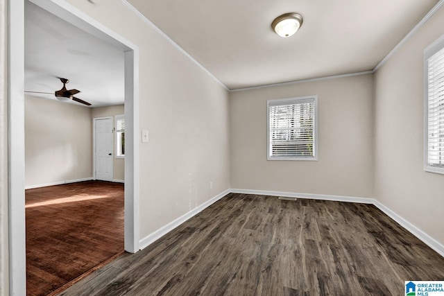 empty room with ceiling fan, dark hardwood / wood-style floors, and ornamental molding