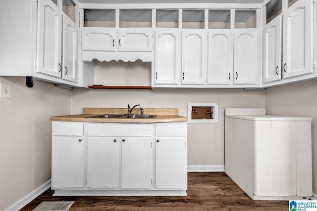 washroom featuring cabinets, washer hookup, dark hardwood / wood-style floors, and sink